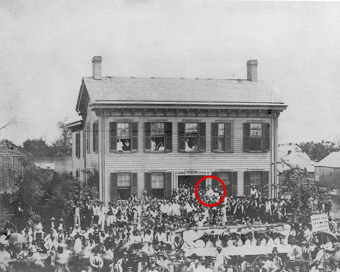ALPLM's tweet photo. 162 years ago, a campaign march stopped at the Springfield, Ill., home of a lawyer/politician (the tall fellow in the white jacket, circled in red). If the crowd wasn't sure which house was his, they could check the name on the door. #ArchivesOnMyStreet #ArchivesHashtagParty https://t.co/ZaBeXfrJHW