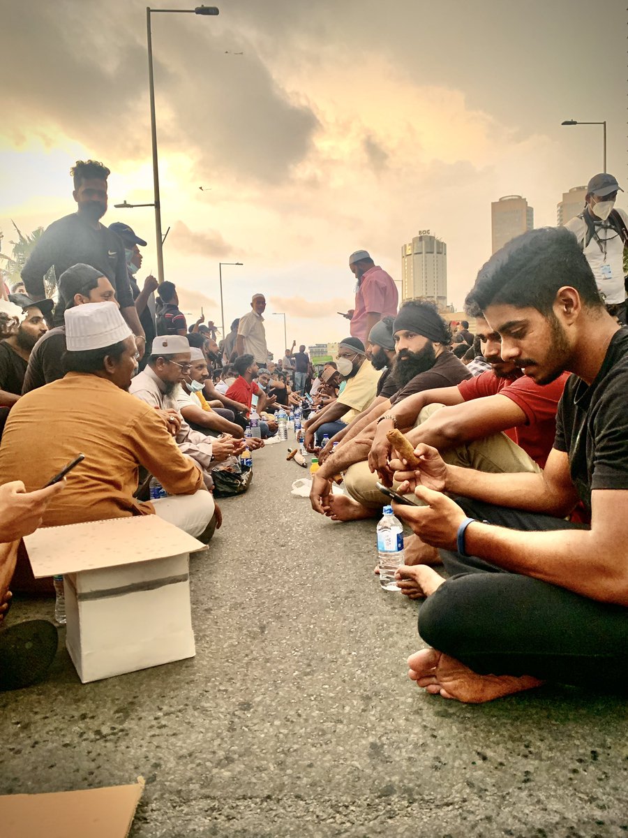 roelraymond's tweet photo. Was really beautiful watching the solidarity amongst everyone at the protest today. Here, Muslims are seen breaking fast after a long day of protesting. This is the #SriLanka we want. #lka https://t.co/yvRVeihyGQ