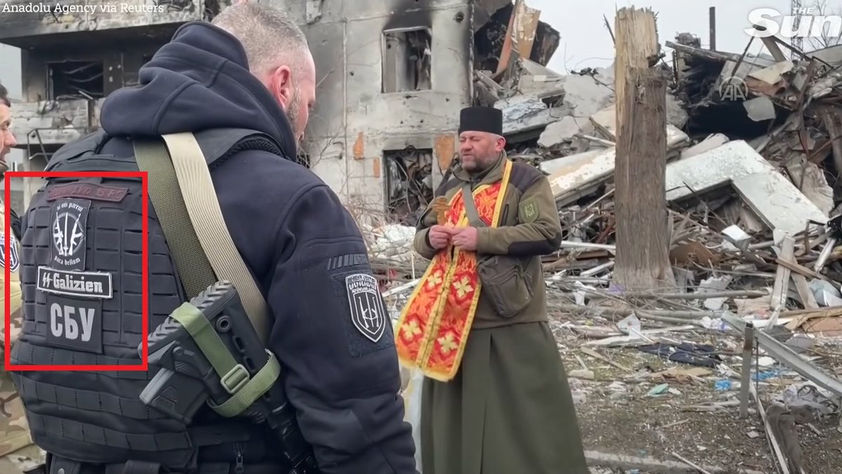 SputnikInt's tweet photo. The SS symbols on the Security Service of Ukraine (SBU) officer's uniform have been captured by the British journalists from The Sun in the Kiev region. 
If anyone still has doubts... https://t.co/Z6ik3SMzd2
