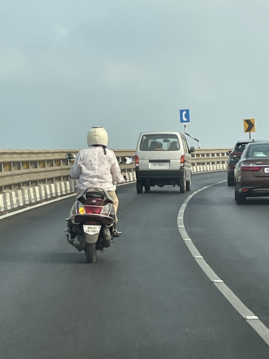 AmitBhadricha's tweet photo. .@MumbaiPolice lady staff using Bandra Worli Sea Link when 2 wheeler is not allowed.

@MTPHereToHelp kindly take strict action.

Cc @CPMumbaiPolice https://t.co/QIuhZYqAZi