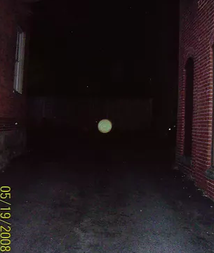 HauntFootsteps's tweet photo. A solitary possible #spiritorb hovers in the driveway of the Joshua Ward House. With the original, stone foundation in sight on the left, the centered green orb makes for an intriguing sight, whether it's a true spirit or just a smudge on the lens. #haunted #salemma https://t.co/1VxryYWPrO