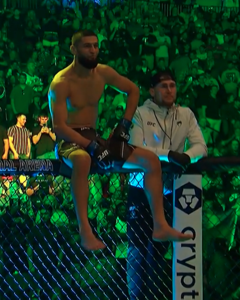 MMAFighting's tweet photo. Khamzat just casually sitting on the cage as Gilbert walks out 👀 #UFC273 https://t.co/Lwh58eWSpd