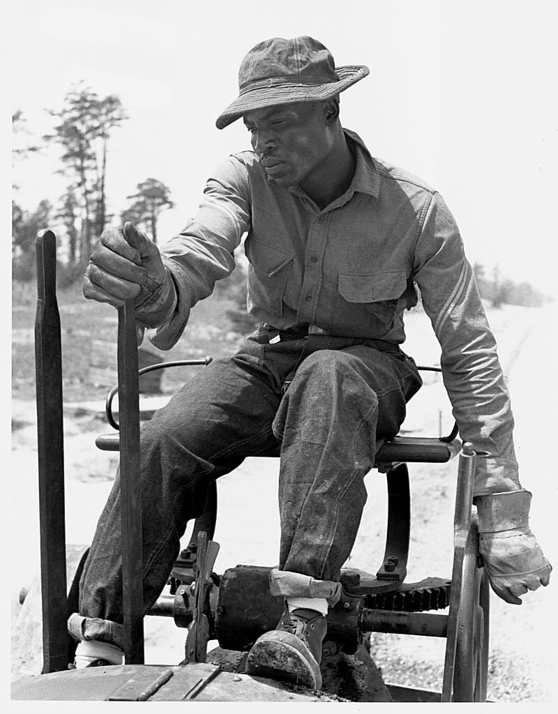 Prince George's County, Maryland (1940). A man enrolled in the Civilian Conservation Corps paves a road in Beltsville. The CCC was a gov't agency that employed men btwn 18-25 to work on America's public lands, forests, and parks.