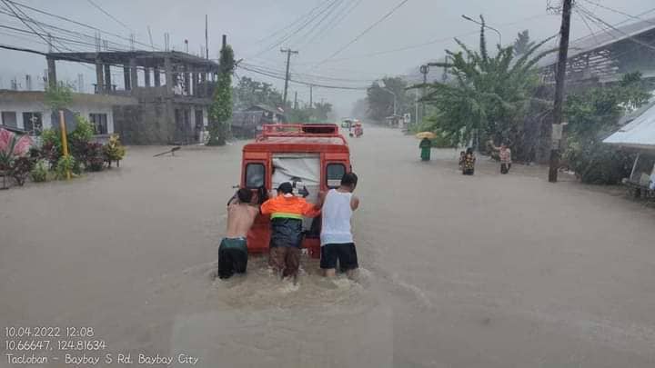 PhilippineStar's tweet image. Individuals brave the floodwaters along South Rd., in Brgy. Gaas, Baybay City, Leyte on Sunday due to #AgatonPH. The road is not passable to light vehicles as of 1:30 PM. (Photos courtesy of DPWH) | via Miriam Desacada