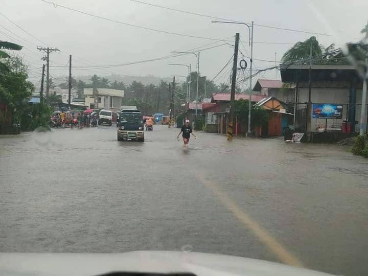 PhilippineStar's tweet image. Individuals brave the floodwaters along South Rd., in Brgy. Gaas, Baybay City, Leyte on Sunday due to #AgatonPH. The road is not passable to light vehicles as of 1:30 PM. (Photos courtesy of DPWH) | via Miriam Desacada