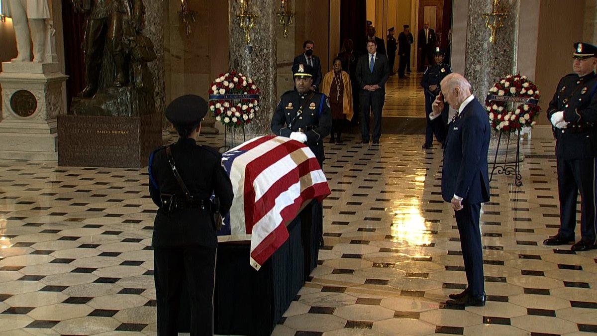 DJJudd's tweet photo. President Joe Biden makes the sign of the cross before laying his hands on the casket of Rep. Don Young, lying in state in the US Capitol today. https://t.co/r8CAWYGHtu