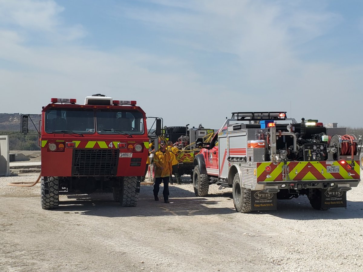 Leander_Fire's tweet photo. Crews from Leander, Cedar Park, and Round Rock FDs spent the day working fire lines at Fort Hood on the #CrittenbergComplex. Shown here are crews refilling from a Fort Hood mobile water supply, a firefighter on the fire line, and providing fire support to military dozer crews. https://t.co/LBU1p5Lmbi