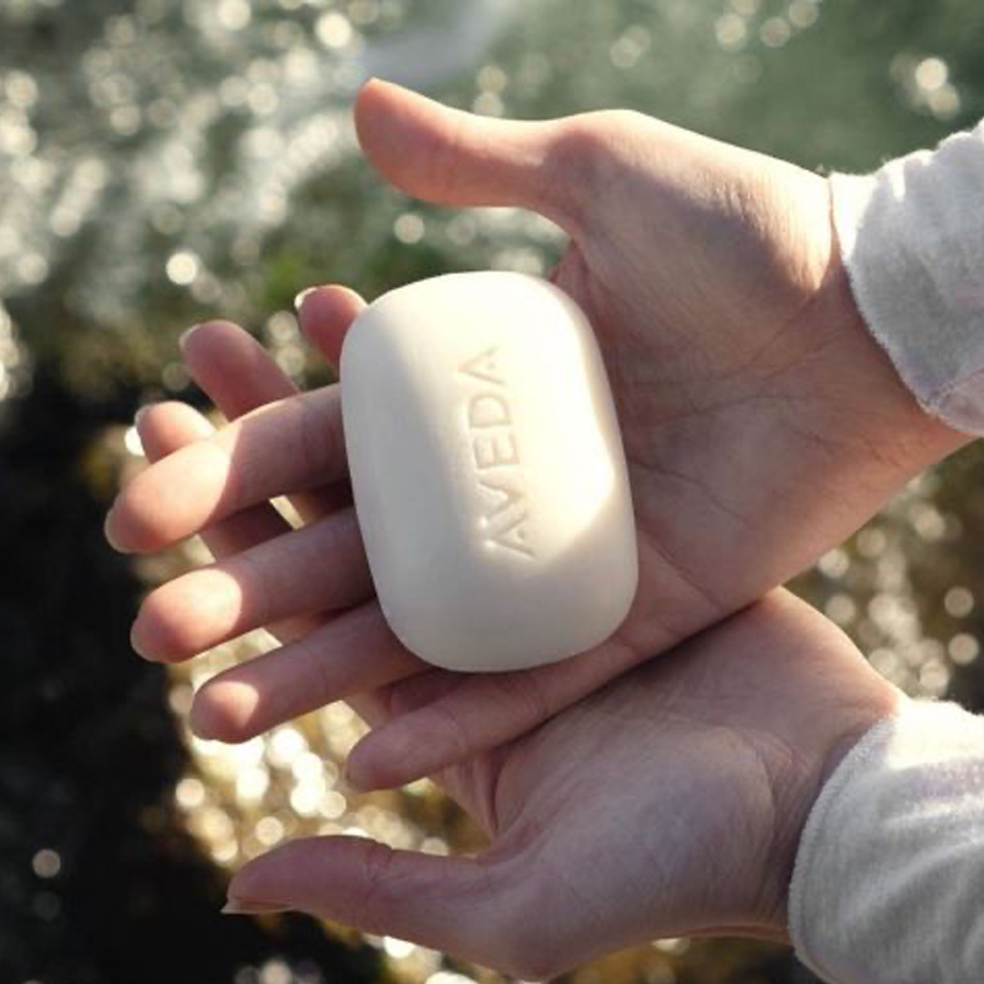 aveda's tweet photo. Change in the palm of your hands––add one simple addition to your existing hair care routine with our vegan, silicone &amp; sulfate-free Shampure Shampoo Bar, made with sustainably sourced palm derivatives. We’re donating to @charitywater for every bar purchased all Earth Month long. https://t.co/SzADjZ1l9G