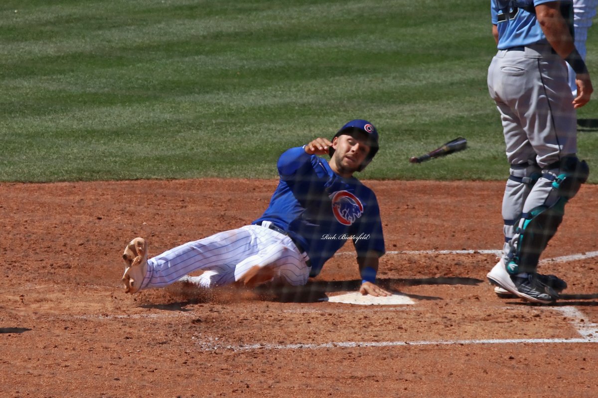 biest22's tweet photo. A pair of @Cubs - @NickMadrigal_3 and Frank Schwindel - sliding safely into home during Wednesday's game against the Mariners. #Cubs #ST2K22 https://t.co/hxZ7XJZubb