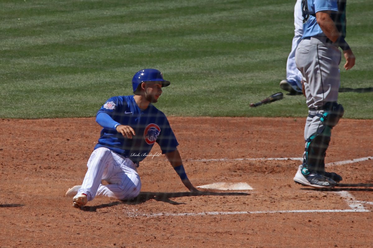 biest22's tweet photo. A pair of @Cubs - @NickMadrigal_3 and Frank Schwindel - sliding safely into home during Wednesday's game against the Mariners. #Cubs #ST2K22 https://t.co/hxZ7XJZubb