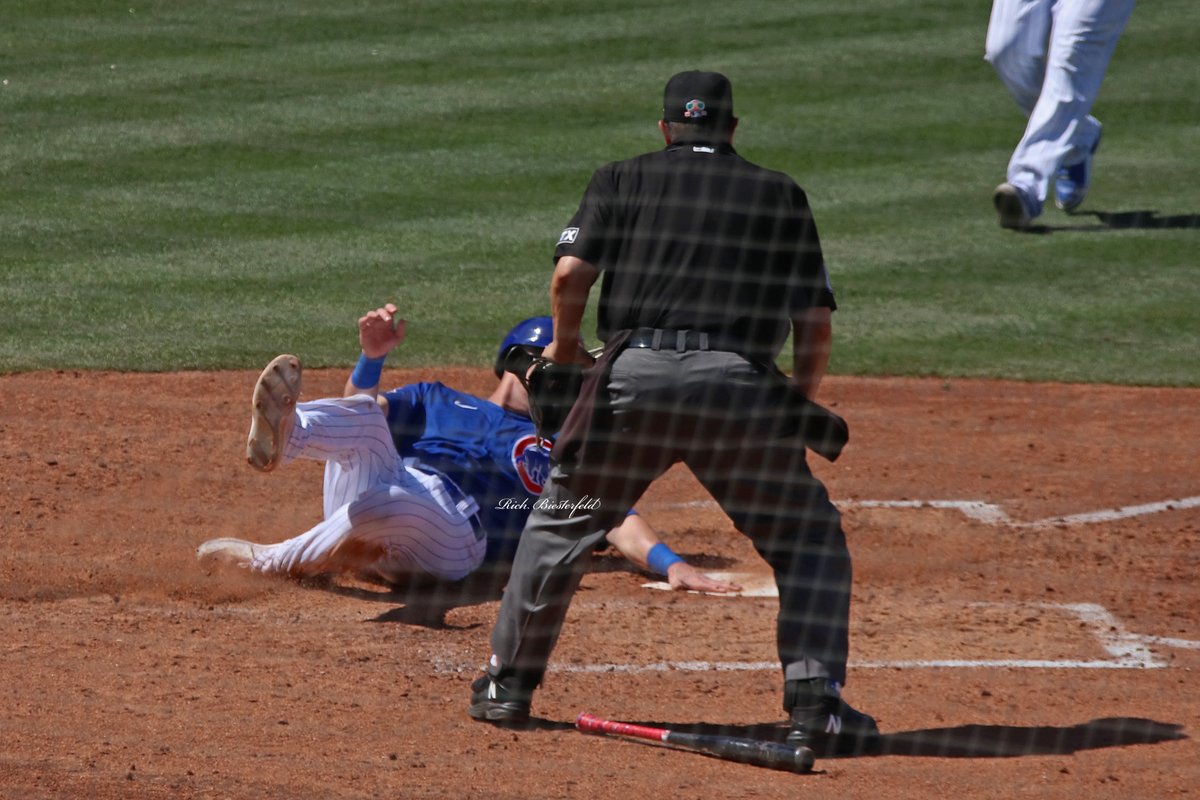 biest22's tweet photo. A pair of @Cubs - @NickMadrigal_3 and Frank Schwindel - sliding safely into home during Wednesday's game against the Mariners. #Cubs #ST2K22 https://t.co/hxZ7XJZubb