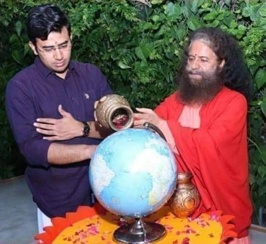 PKakkar_'s tweet photo. Which act is dumber? 

.@Tejasvi_Surya as a politician whose solution to global warming is pouring holy water on a globe? 

Or 

@Tejasvi_Surya as a lawyer to be caught on the camera for leading a mob to commit crimes which could turn heinous. https://t.co/aHoxMPa8JI
