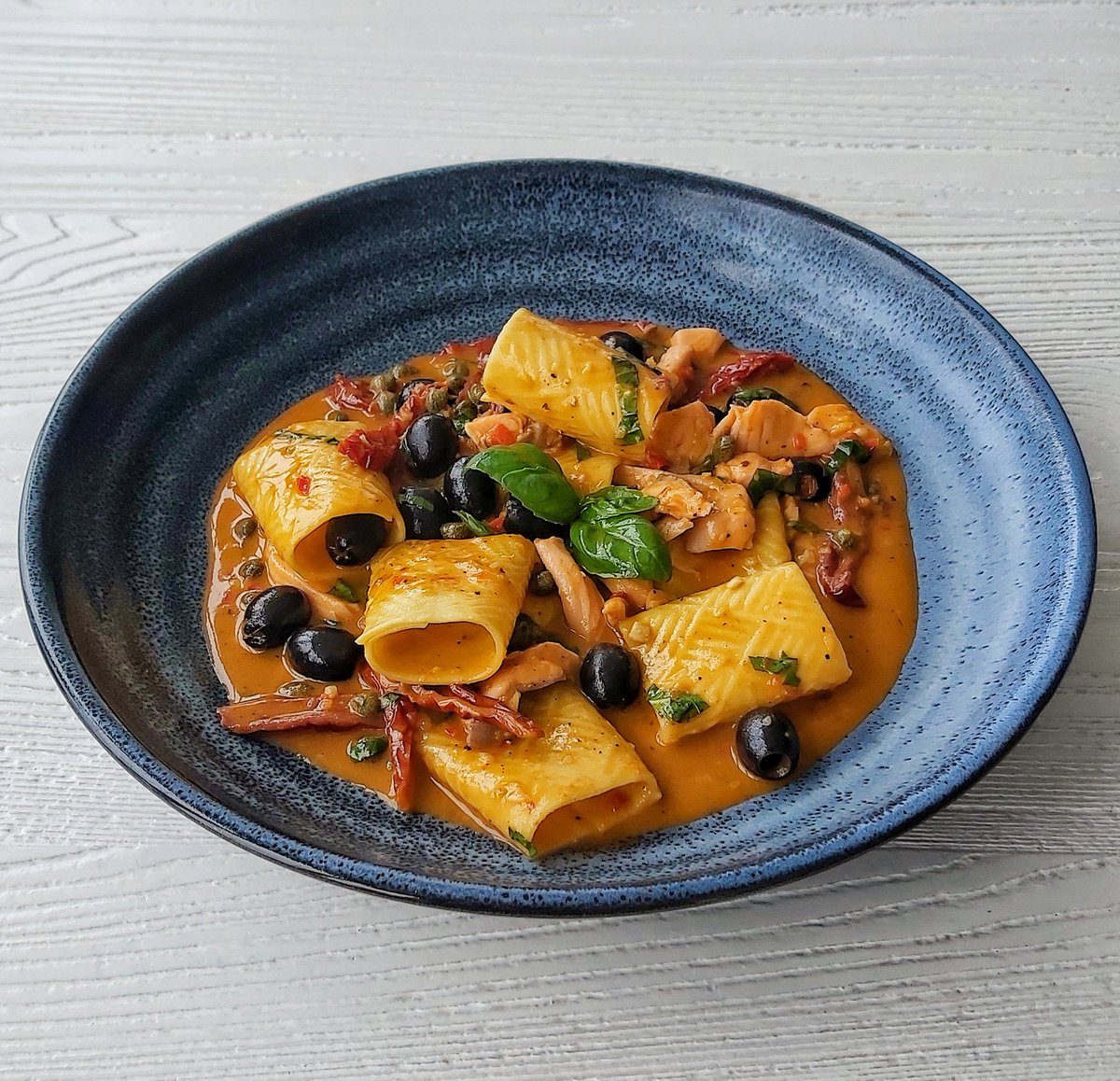 Paccheri pasta, Irish salmon, sun dried tomato puttanesca sauce, fresh basil.