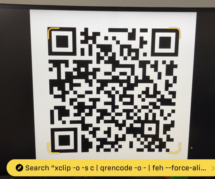 A screenshot from the iOS camera app. A QR code is showing in full screen on my monitor, and iOS has annotated it with the QR's contents:

xclip -o -s c | qrencode -o - | feh --force-aliasing -ZF -
