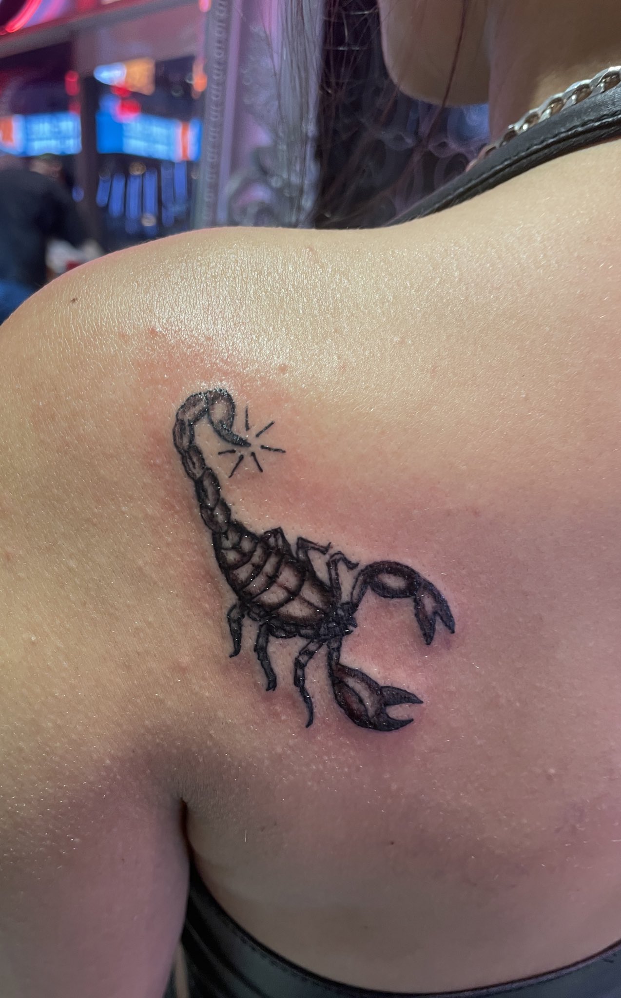Line art scorpion tattoo on the forearm.