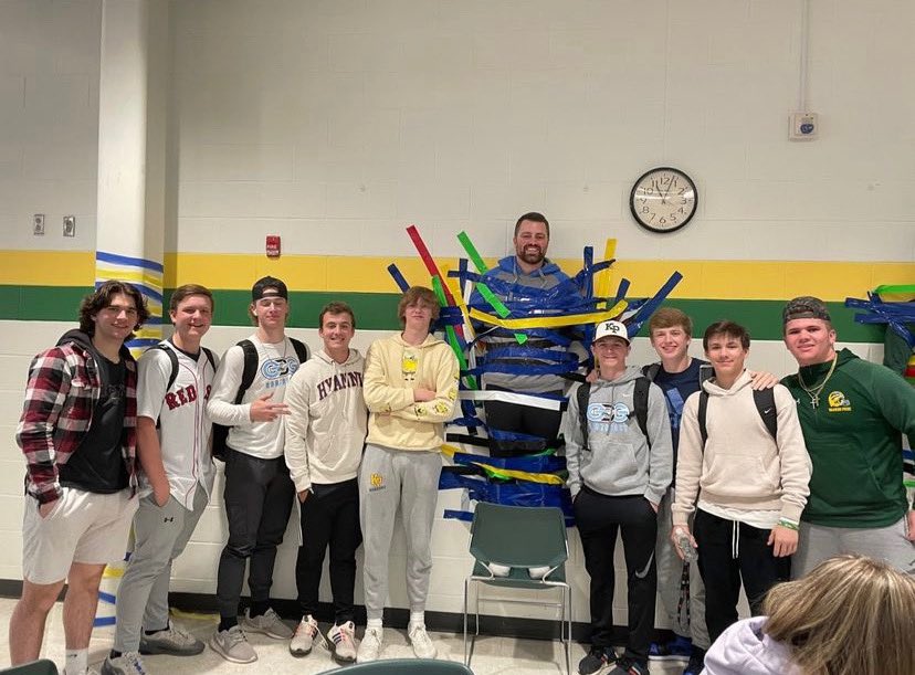 CoachPlympton's tweet photo. Shout out to KP Cares for putting on the Strike Out Cancer event today! Myself and Coach Lee got taped to the wall during lunch! Varsity squad jumped on their chance to tape their coach to the wall! https://t.co/uQ4vuSZCsV