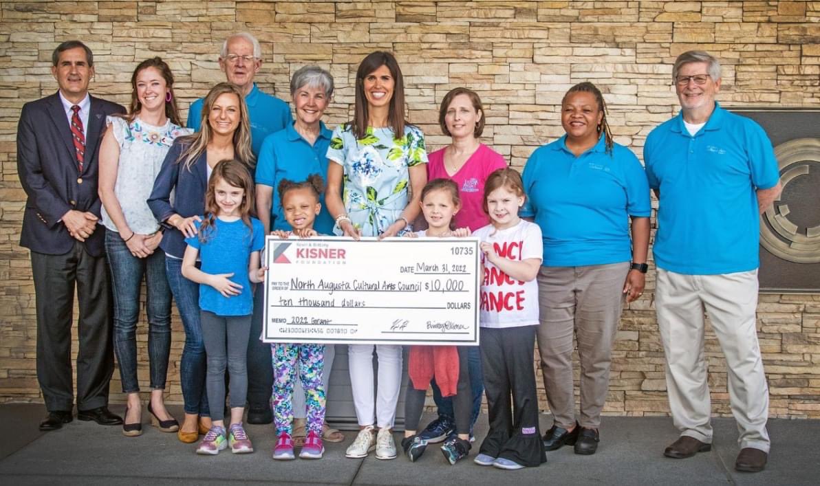 RRNEWS12's tweet photo. The new News 12 NBC 26 building makes the perfect backdrop for this big check presentation by the Kisner Foundation. Huge turnout by the North Augusta Mayor, members of the North Augusta Cultural Arts Council, two dance studios, students and Brittany Kisner!
#kisner #golf https://t.co/OPgQsVhtgb