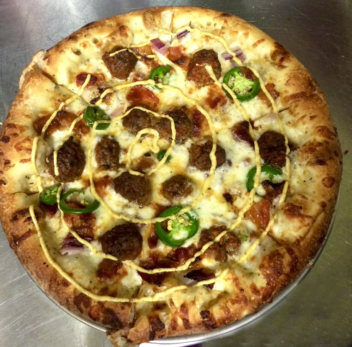 The April special is the Sriracha Meatball Pizza - House-made meatballs and bacon tossed in sriracha sauce , olive oil, roasted garlic, red onion, mozzarella, fresh jalapenos &amp; topped with our spicy sriracha aioli drizzle 🔥
.
#pizza #meatball #meatballpizza #sriracha #eatlocal