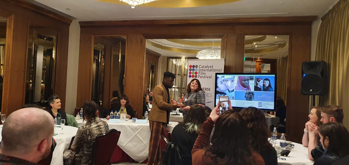 WritersGuildIRL's tweet photo. Congratulations to all the nominees and to Derek Ugochukwu @derekwell who won the @CatalystIntFF Short Screenplay award in association with WGI. Here's the lovely moment WGI Chair @DavidsonJenn presented David with his award #DiverseStories #DiverseStorytellers https://t.co/mzF32nGgns