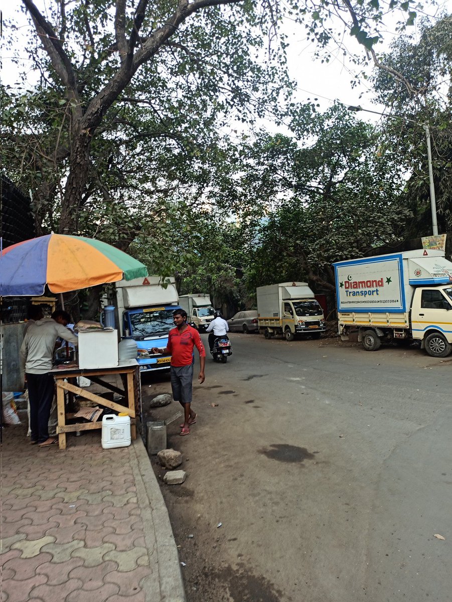 abneesh's tweet photo. Footpath in Windsor lane in Kalina, Santa Cruz east. Vada pav stall has taken up full footpath, uses gas cylinder (banned on street). an old sofa put by truck drivers. Both sides of street have 10 trucks parked at night till 11 am. No space to walk on footpath Or road. Pl help https://t.co/gxDtEB6Vrl