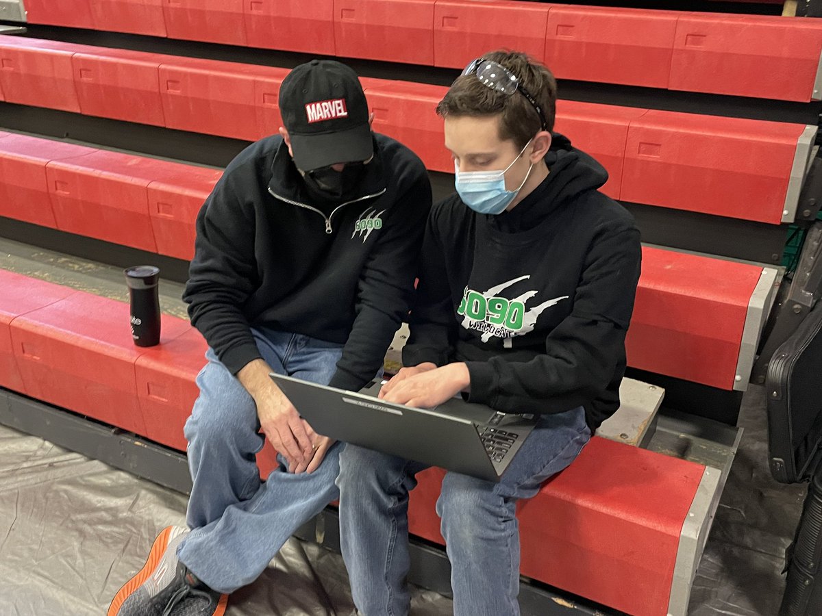 Pit crew and code are hard at work to make our robot the best it can be.