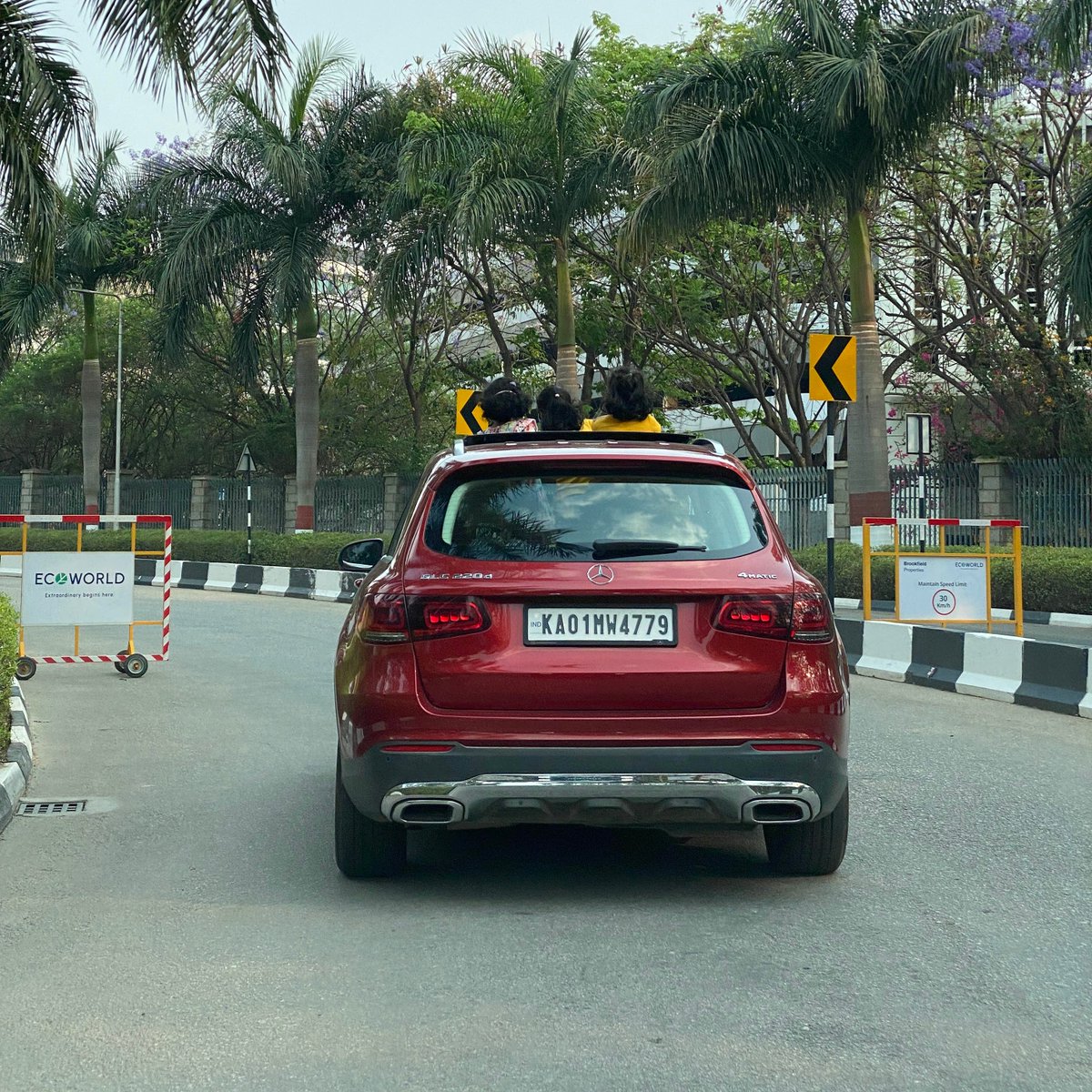 Rajkiran's tweet photo. @blrcitytraffic Please take punitive action against these people - there are 3 kids sticking their head out of the sunroof. Location is RMZ Ecoworld Campus in Bellandur. https://t.co/UlmjH2iZEx