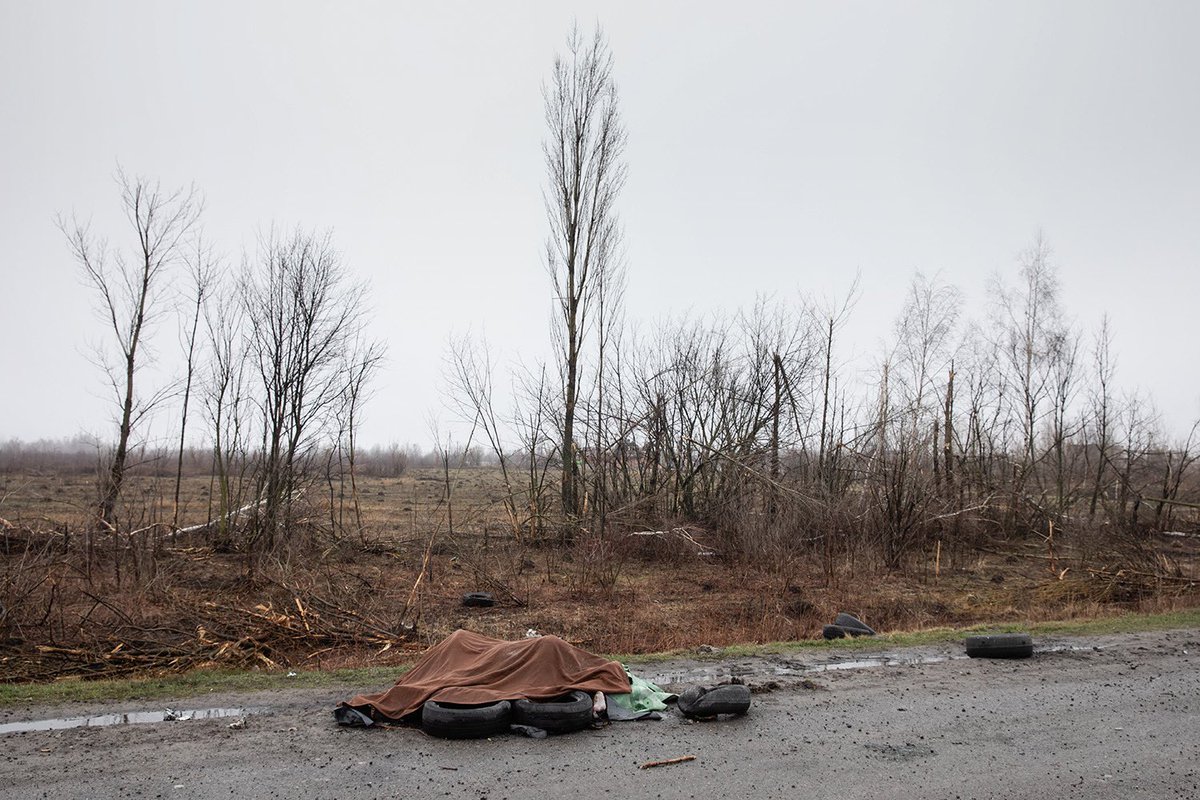 Dead civilians are seen on the sidelines of highway 20km from Kyiv, Kyiv region, Ukraine April 2, 2022. Under the blanket 4 or 5 dead naked women whom tried to be burned on the roadside.