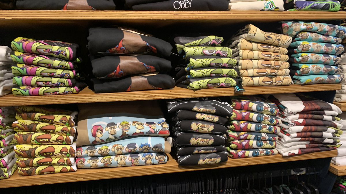 is this real life? just went to the mall for the first time in forever and i find a wall of <a href="/BoredApeYC/">Bored Ape Yacht Club 🍌</a> merch! it’s happening people!!! 🤯