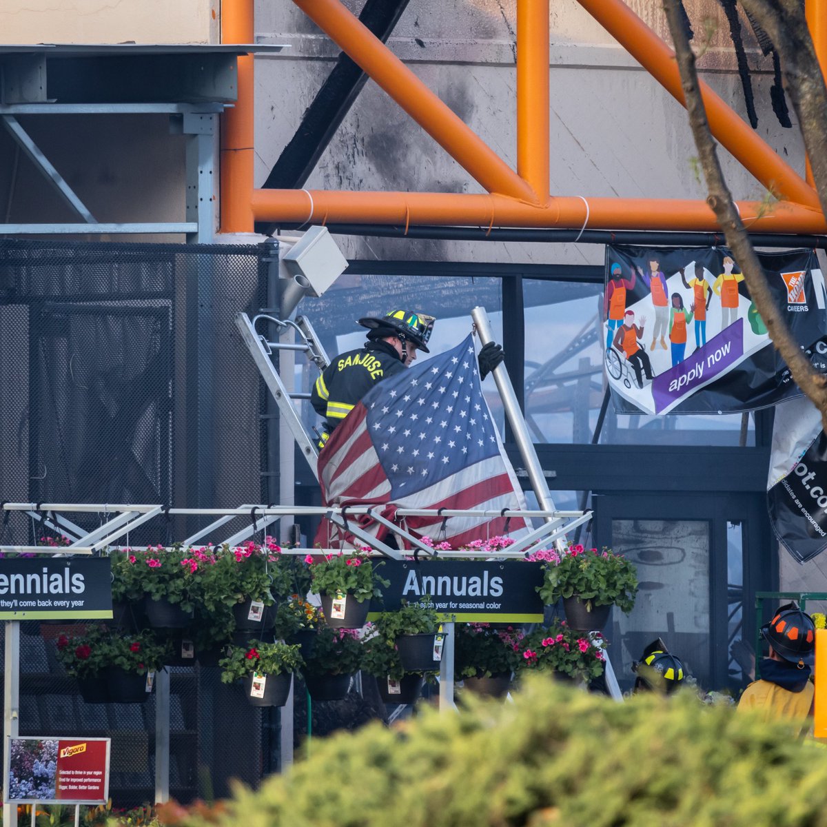 San Jose firefighters removing the flag from the Home Depot on Blossom Hill, which burned down yesterday. A fire seen for dozens of miles and from space, it is no small miracle the flag survived. #homedepotfire #HomeDepot #sanjose #firefighters