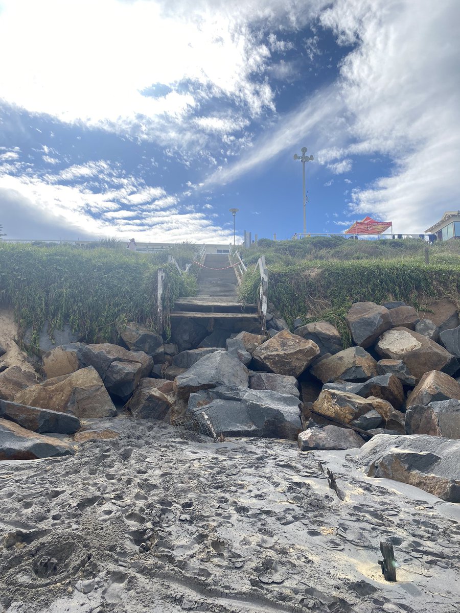 Tom_P_Newman's tweet photo. The results from the recent swell at #DixonPark. The wooden stairs hadn’t been uncovered since I was in Nippers, now almost gone! A reliable source (dad) says he sat on the rocks in 78 before a surf and they were covered in early 80s. Check out the magazine’s date from the dune👀 https://t.co/2ySCHUvI6P