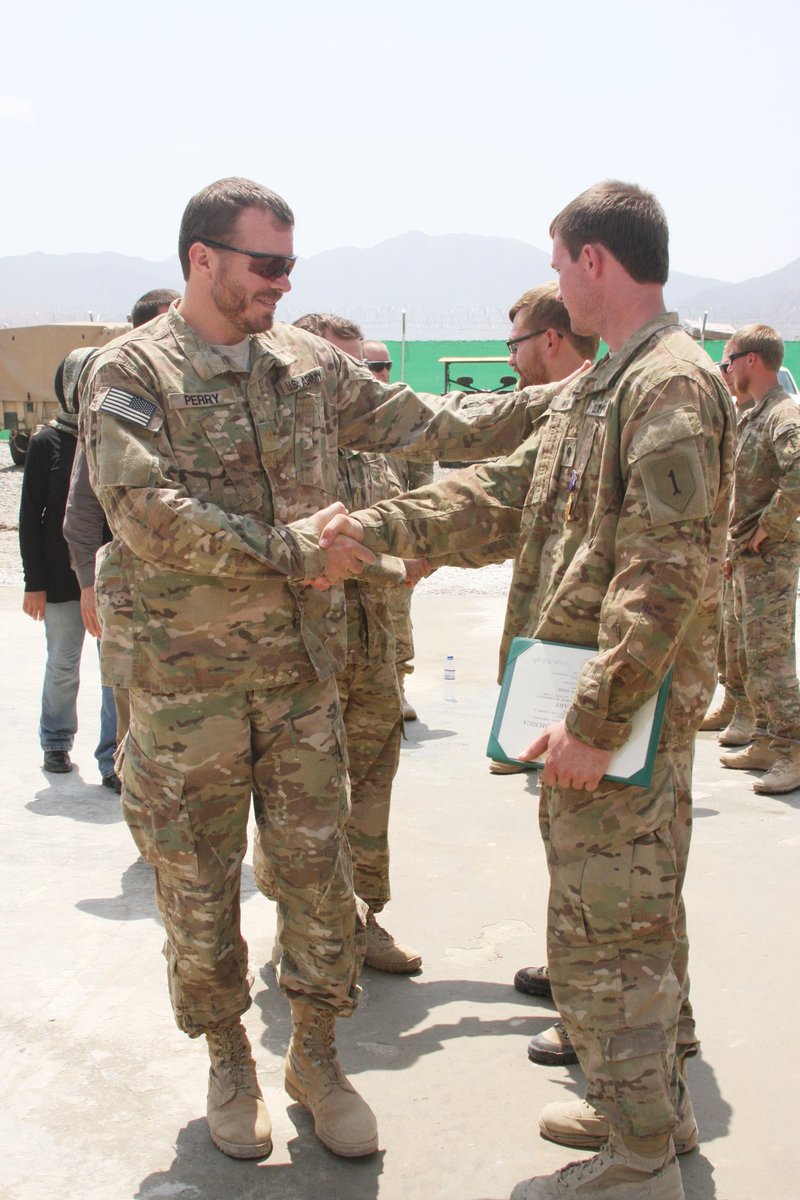 MikePerryavatar's tweet photo. Here's then Colonel Donald Bolduc in the background wearing shades. He took a day off from losing the war in Afghanistan to come schmooze Miller, who's next to him, at a Purple Heart ceremony for 2 young soldiers who soaked up some RPG fragments. https://t.co/8uuiF5faDF