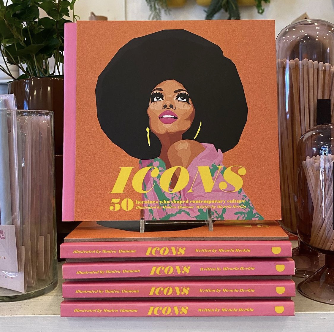 A stack of ICONS surrounded by pink-colored decor