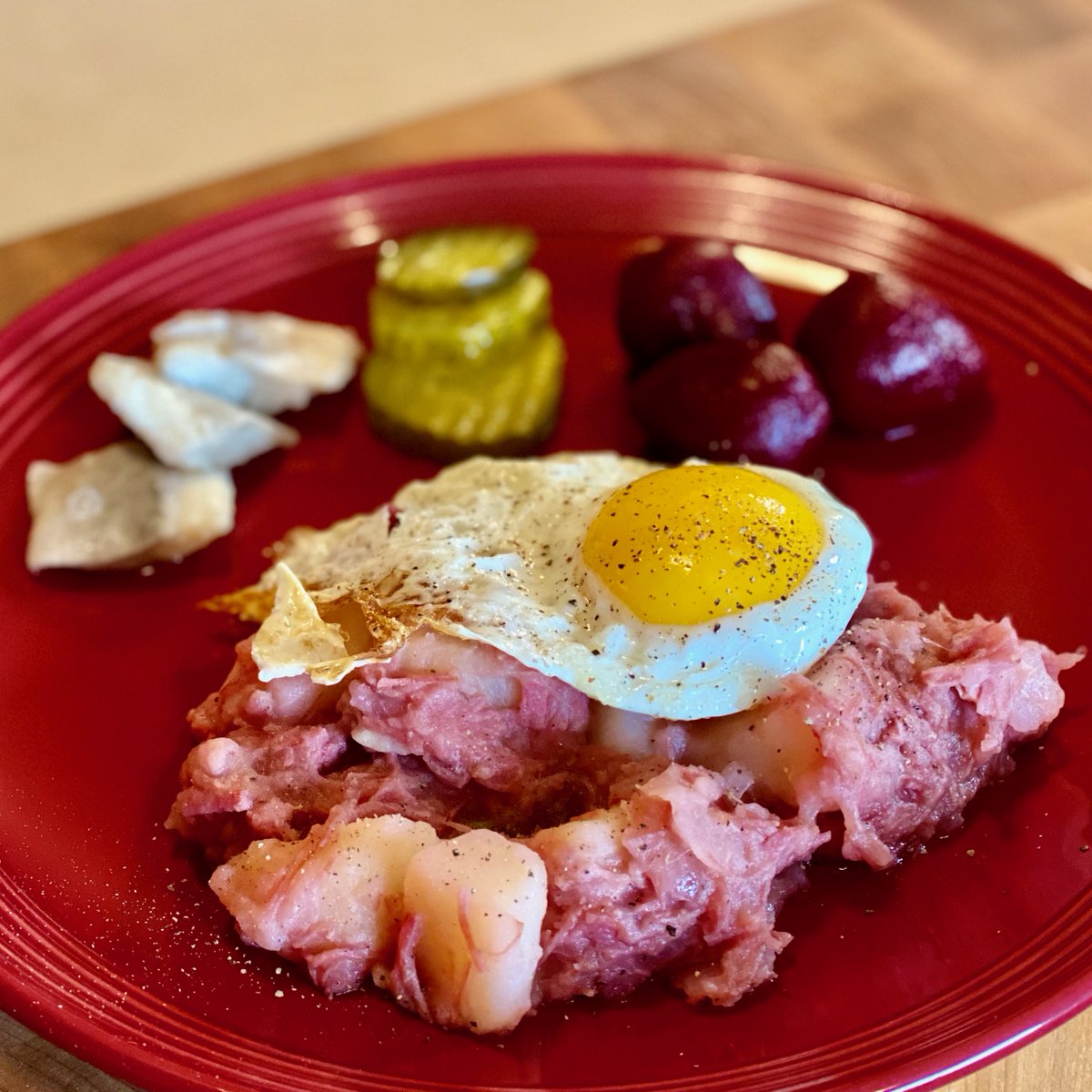 MrsMommy's tweet photo. Tonight we tried a new recipe from the Easy German Cookbook...Labskaus (corned beef hash with beets). I served it with a fried egg on top, and a trio of pickled items...herring, cucumbers, and baby beets. #GermanCooking https://t.co/ZBXatpgire