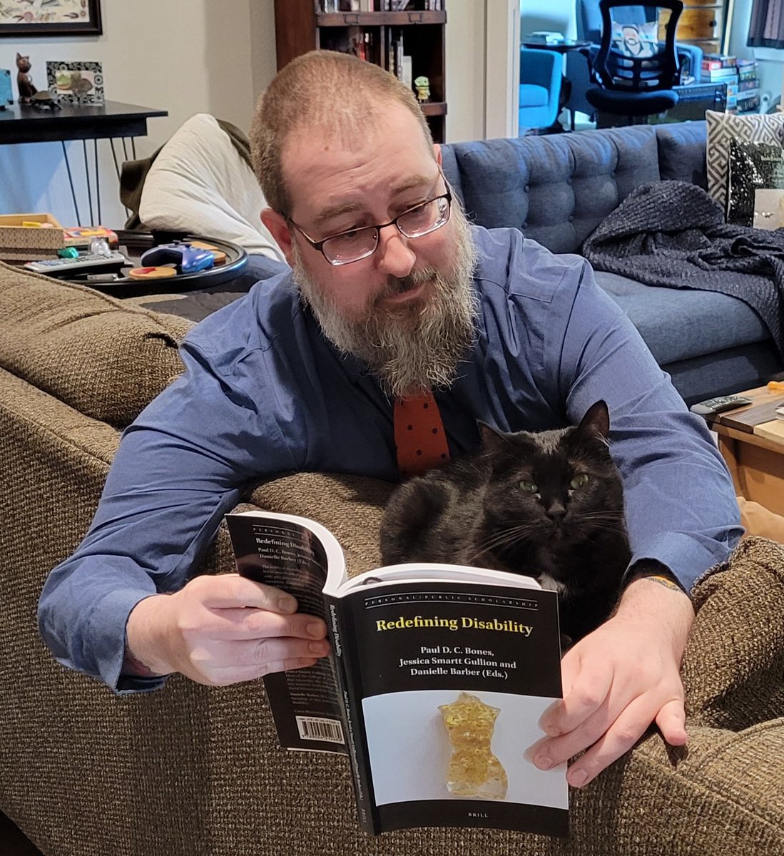RoboticoEl's tweet photo. Inspired by @L_Historienne, I decided to do a photo shoot to celebrate the release of #RedefiningDisability. My shots aren't as good as hers, but it was kind of fun.
Millie seems interested in the book! Mostly. https://t.co/fHuScBIkFz