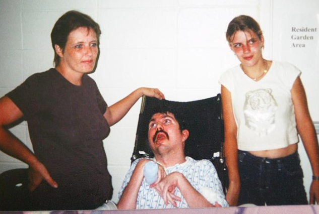 Terry Wallis, center, his wife Sandra, left, and their daughter Amber at a rehabilitation center in Mount View, Ark., in 2002. (Getty Images file)
