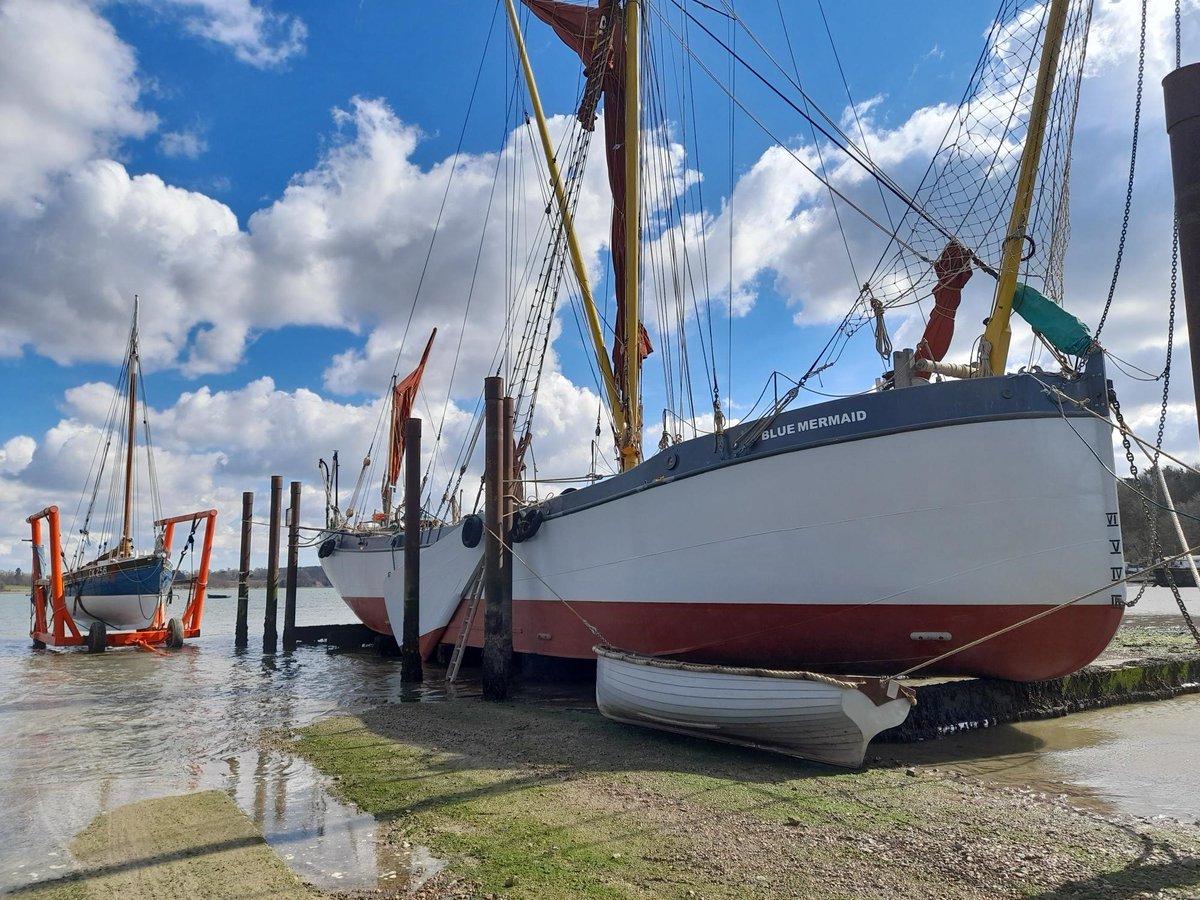 SeaChangeTrust's tweet photo. Finally finished painting between gales and snow showers Blue Mermaid waits patiently on the blocks for departure and our first residential trip of the season.  Meanwhile Aldous smack Hyacinth waits for water to go on her new mooring on the River Orwell.
#seachangesailingtrust https://t.co/1jk0ghTBuJ