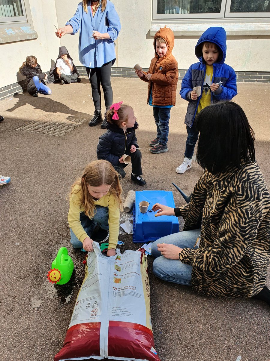 Planting sunflower seeds. I wonder how tall they will grow?