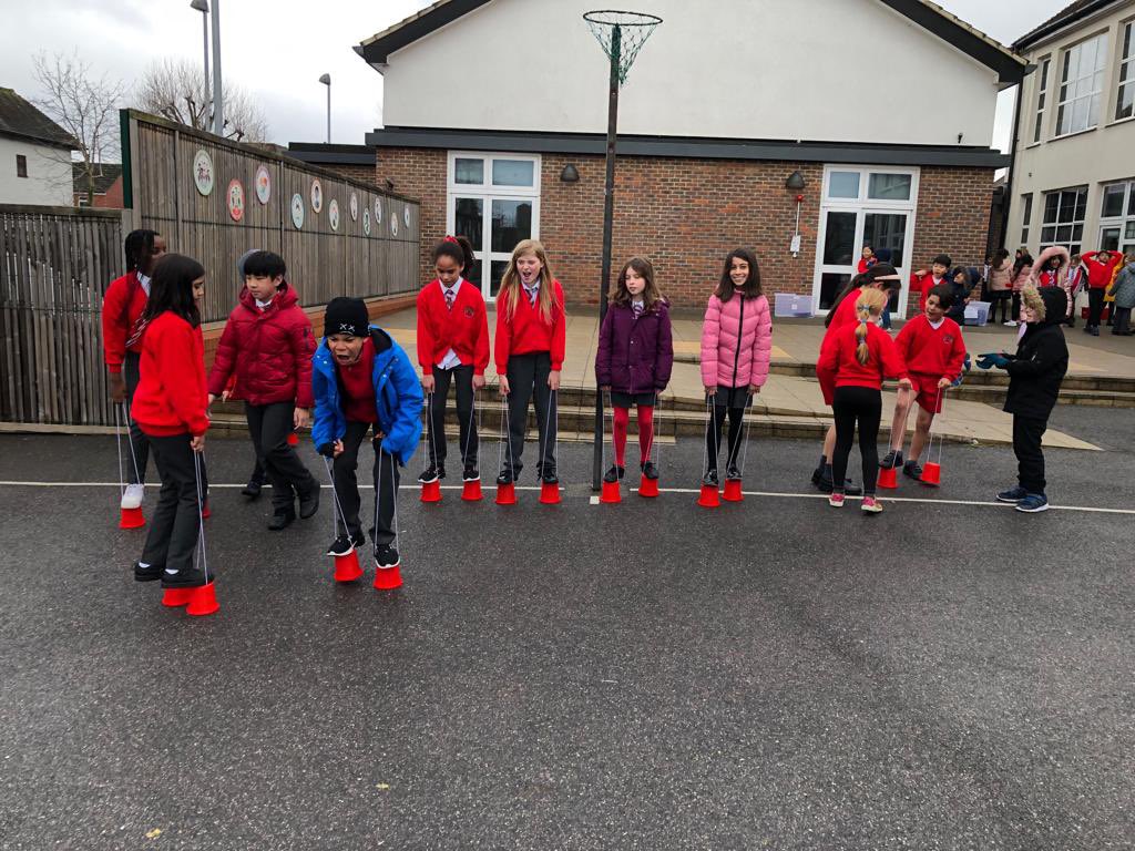 CCJacademy's tweet photo. The rain stopped and the children were able to enjoy our craze of the week is… stilts! @LEOacademies @theresehoyle https://t.co/8RTKXWrIV8