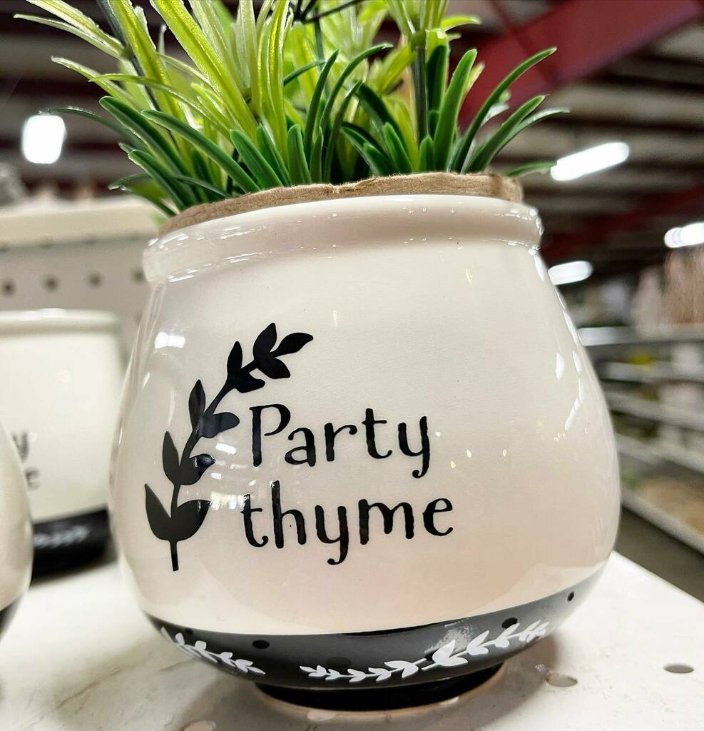 A vase that says "Party Thyme."