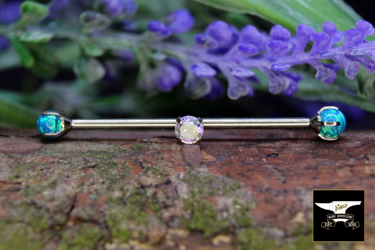 Forge_Jewellery's tweet photo. 14G Titanium Peacock Blue Prong set Opal Internally Threaded Attachments. 
As above fitted to a 14G Industrial barbell with 1 attachment hole. 
As above with 3mm Aurora Claw Set Attachment in center hole. 
Shop QualiTi Now: https://t.co/ks9gwVFtNk https://t.co/QBP8fGZ47d