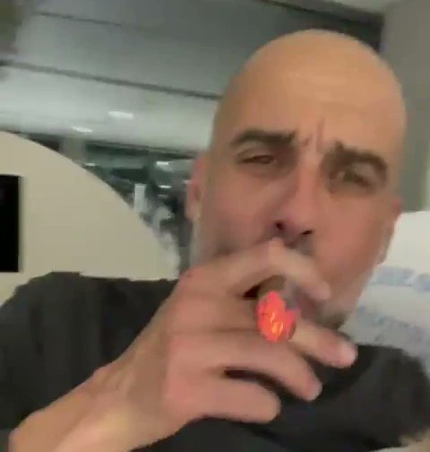 TomYoungSJ's tweet photo. The now iconic image of Pep Guardiola smoking a cigar during City's 2020/21 Premier League title celebrations has been turned into a banner by @WeAre1894 😂👏

📸 (@sam_kenney) https://t.co/7kpyXJ7OC2