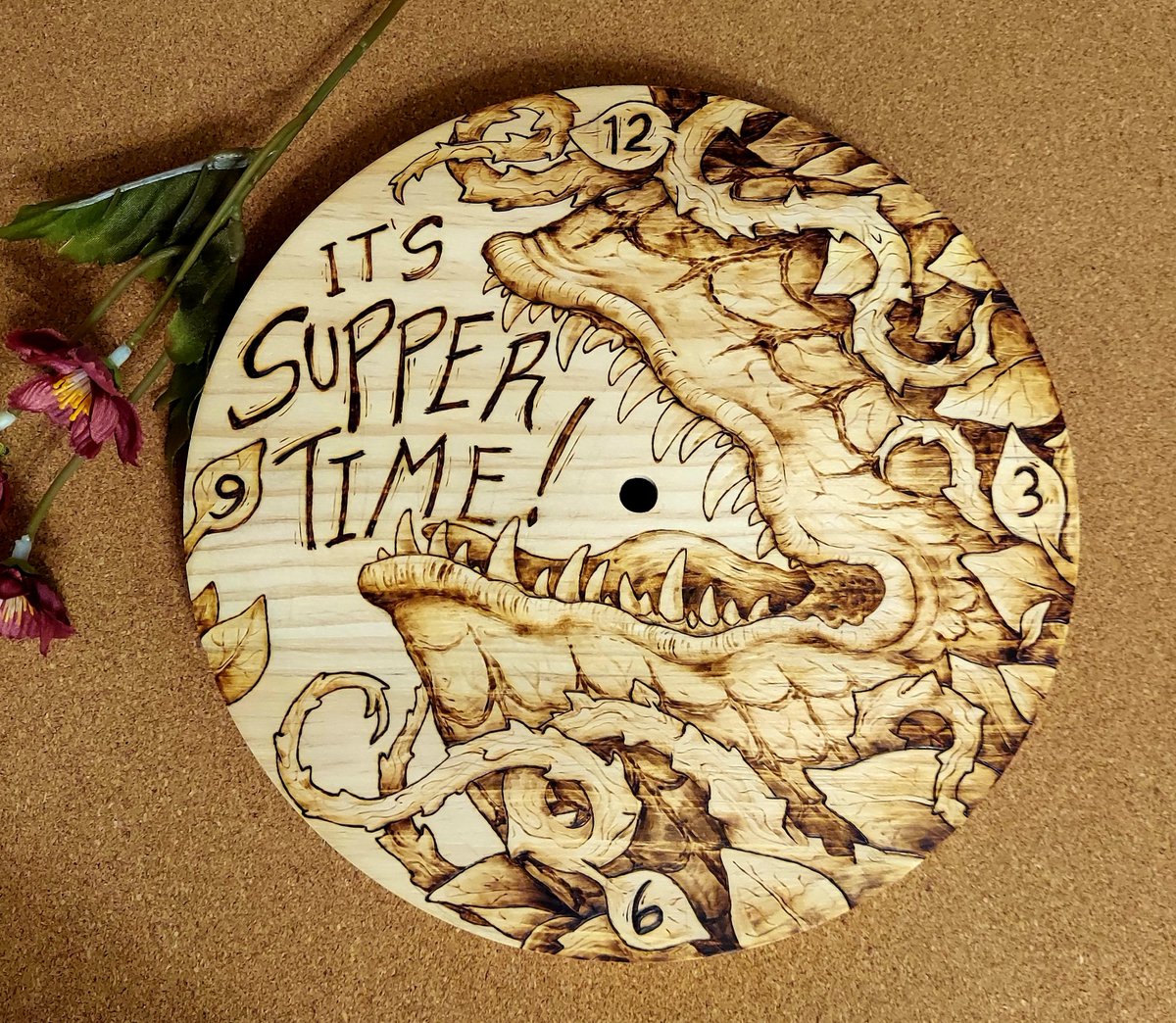 StarboundBear's tweet photo. woodburning: little shop of horrors clock https://t.co/6QeUk4p6Q3