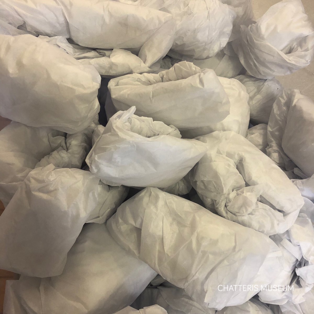 chatterismus's tweet photo. A production line of acid-free tissue paper puffs! Acid-free tissue paper is archival quality so is safe to use in direct contact with artefacts. The puffs provide cushioned support for smaller, more delicate objects within archival boxes.
#MuseumMove
#CollectionRelocation https://t.co/WLo741vgFP