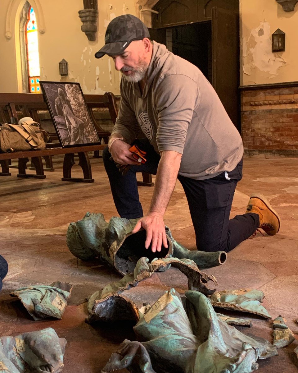 Art conservator Josh Craine of Boston-based Daedalus Inc. looks over the broken pieces of a bronze sculpture, The Writing Lady. The statue was stolen from Riverside Cemetery &amp; hacked to pieces for the cost of the metal. Josh and his team have taken on the challenge to repair it.