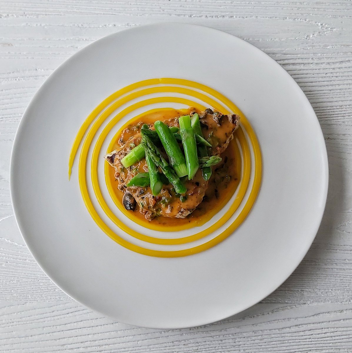 Char- grilled swordfish steak, sun-dried tomato and black olive butter, lemon puree, asparagus spears.