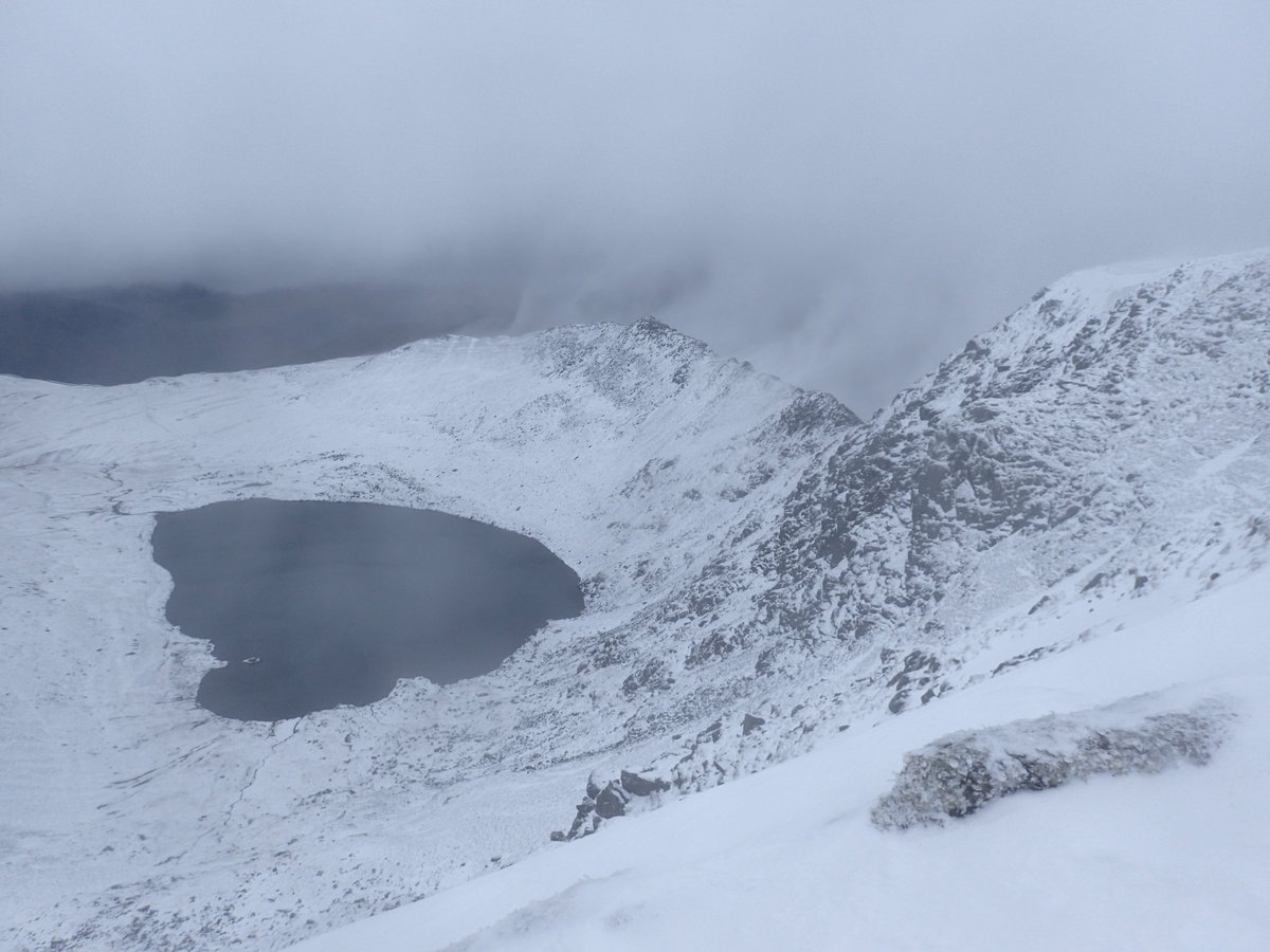 LakesWeather's tweet photo. A welcome return to winter overnight with snow from 600m. This is looking at Red Tarn &amp; hail/spindrift being blown over Striding Edge (looking like cloud on the photo) on a strong NW wind.  Jon https://t.co/rDbmXBHBov