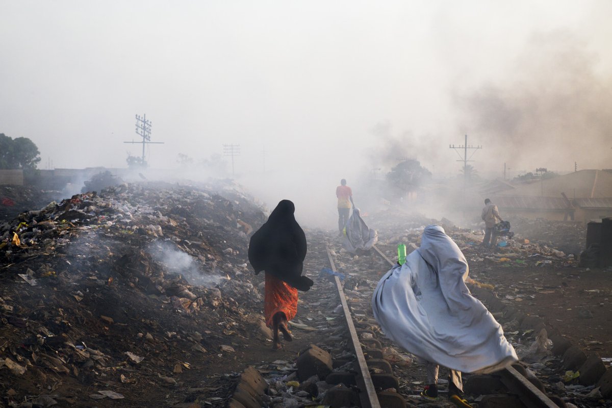 edkashi's tweet photo. From #AbandonedMoments: A Love Letter to Photography, published by @KehrerVerlag. https://t.co/P37IwKdOZk | @edkashi / @VIIPhoto Locals go about their routines, stepping over garbage that burns on the railroad. Kaduna, #Nigeria, 2013 #edkashi #viiphoto #KehrerVerlag #photobook https://t.co/SoIBgbh8fM