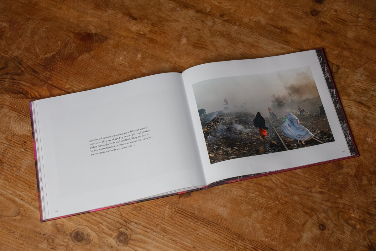 edkashi's tweet photo. From #AbandonedMoments: A Love Letter to Photography, published by @KehrerVerlag. https://t.co/P37IwKdOZk | @edkashi / @VIIPhoto Locals go about their routines, stepping over garbage that burns on the railroad. Kaduna, #Nigeria, 2013 #edkashi #viiphoto #KehrerVerlag #photobook https://t.co/SoIBgbh8fM
