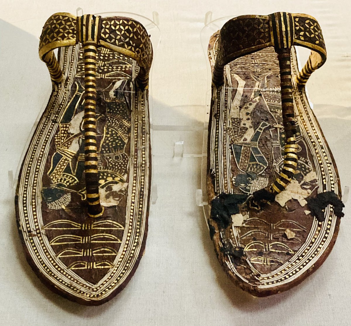 AlisonFisk's tweet image. A pair of sandals from the tomb of Tutankhamun. The soles are decorated with images of bound captives; Egypt’s enemies to be symbolically trodden underfoot by the king. Dynasty 18, reign of Tutankhamun, c.1336-1327 BCE. Egyptian Museum, Cairo. 
📷: my own.

#Archaeology