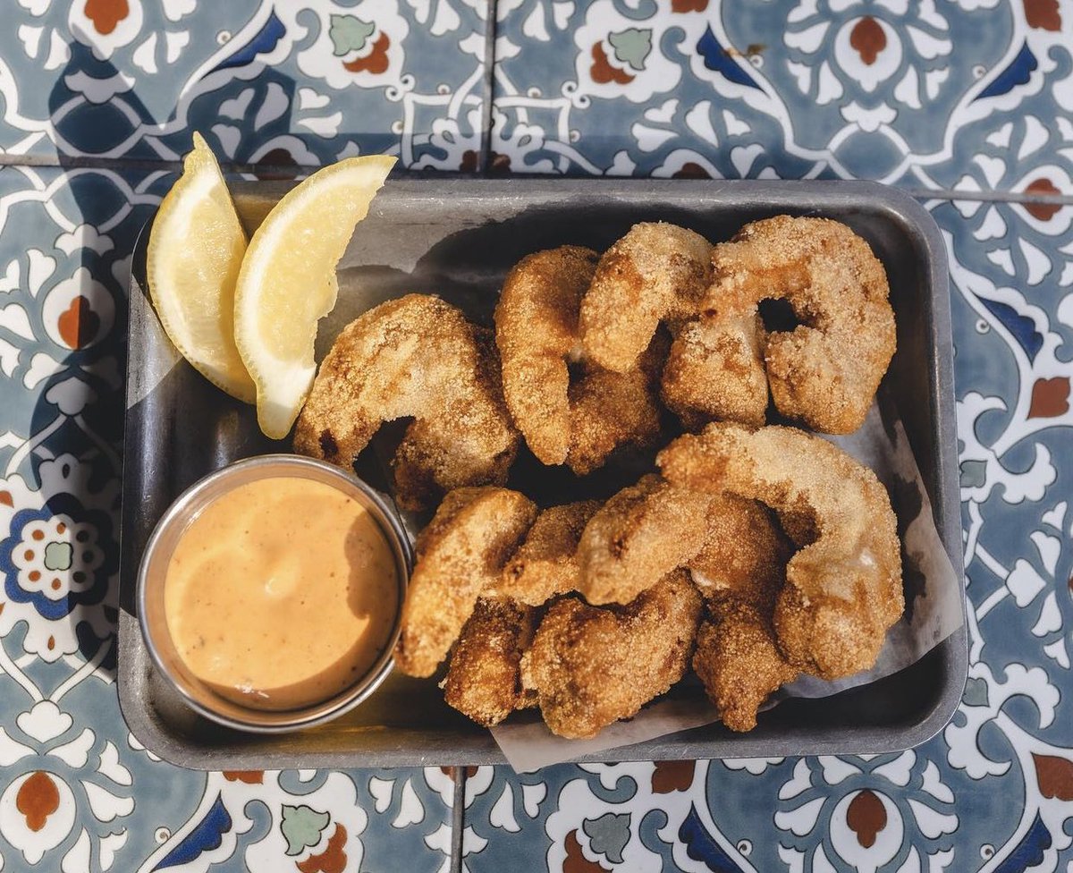 Shrimply the best! Our Fried Shrimp consists of Semolina Crusted Shrimp, Recheado Remoulade, and Lemon Wedge.